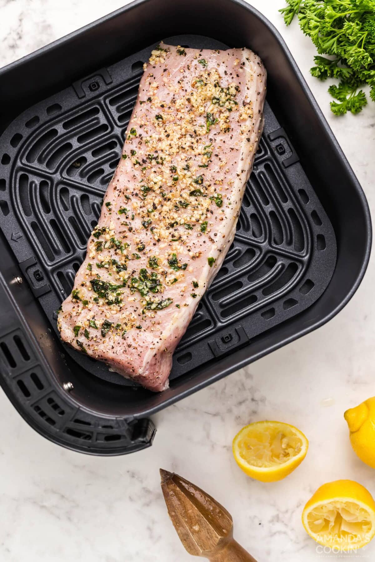 pork tenderloin meat on air fryer grate