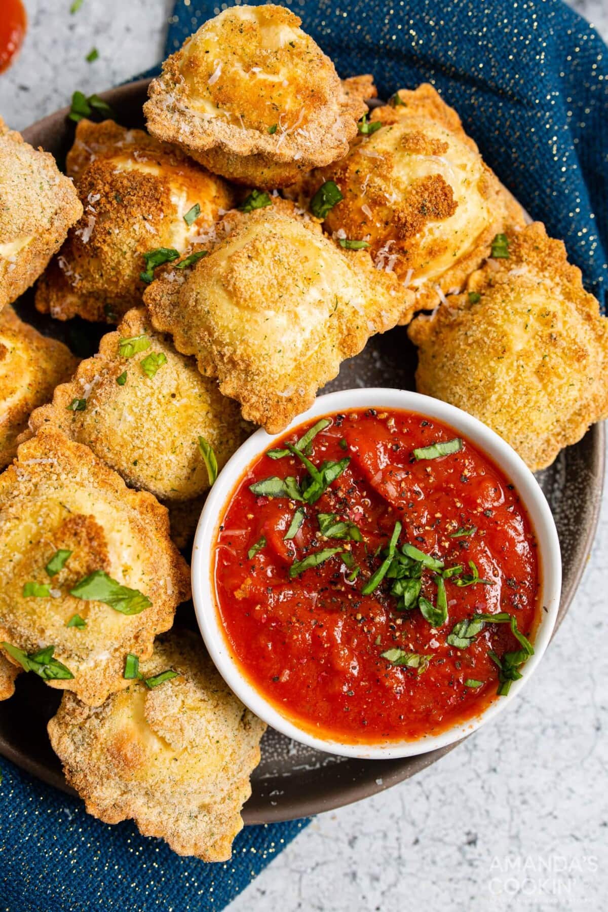 air fryer ravioli on a plate with marinara