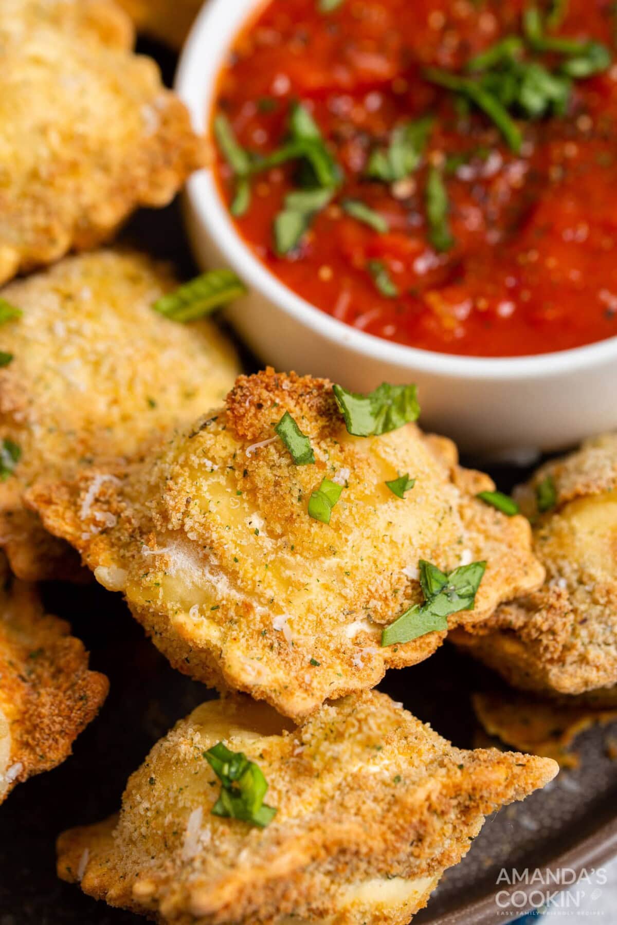air fryer ravioli with dish of marinara