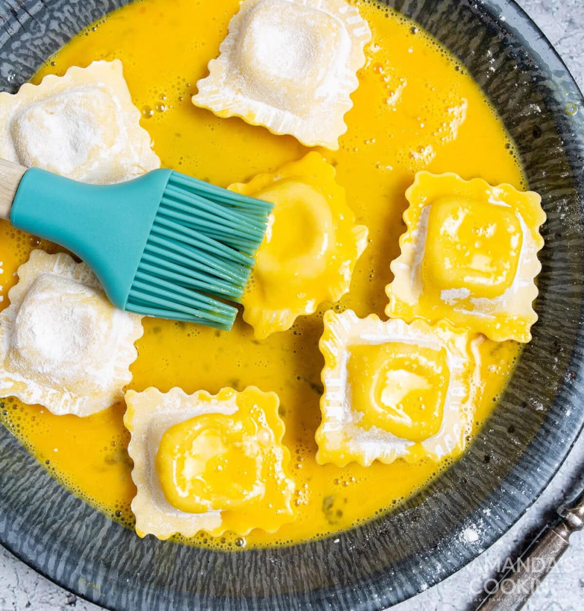 brushing ravioli with egg wash