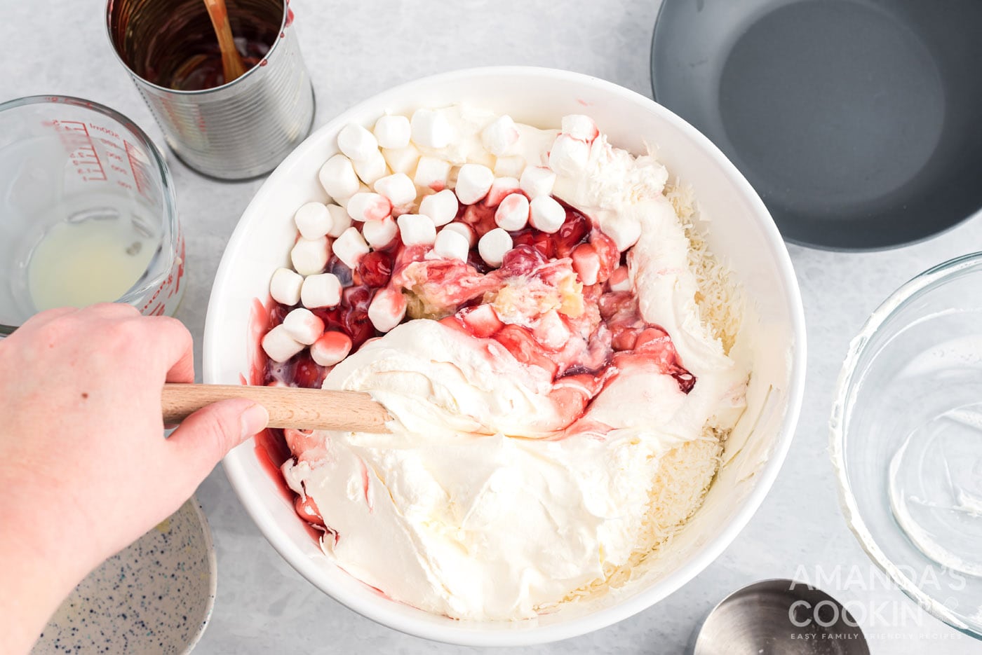 Mixing ingredients for cherry fluff in a bowl