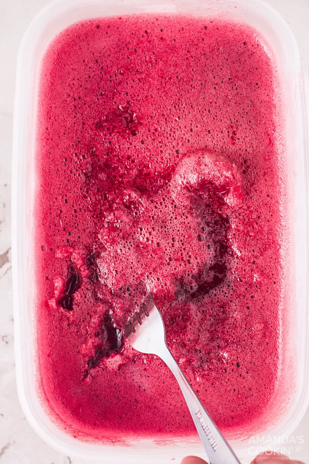scrape cherry ice with a fork