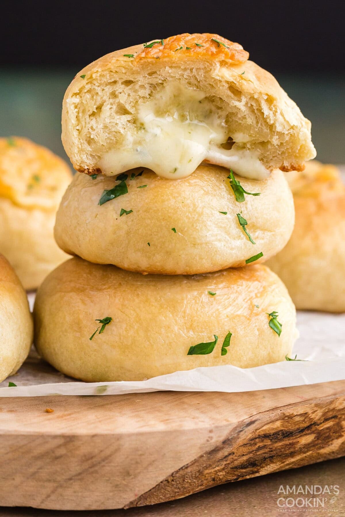 cheese rolls stacked on a cutting board