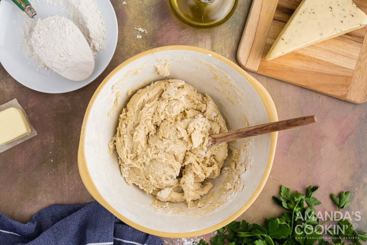 dough in a bowl with wooden spoon