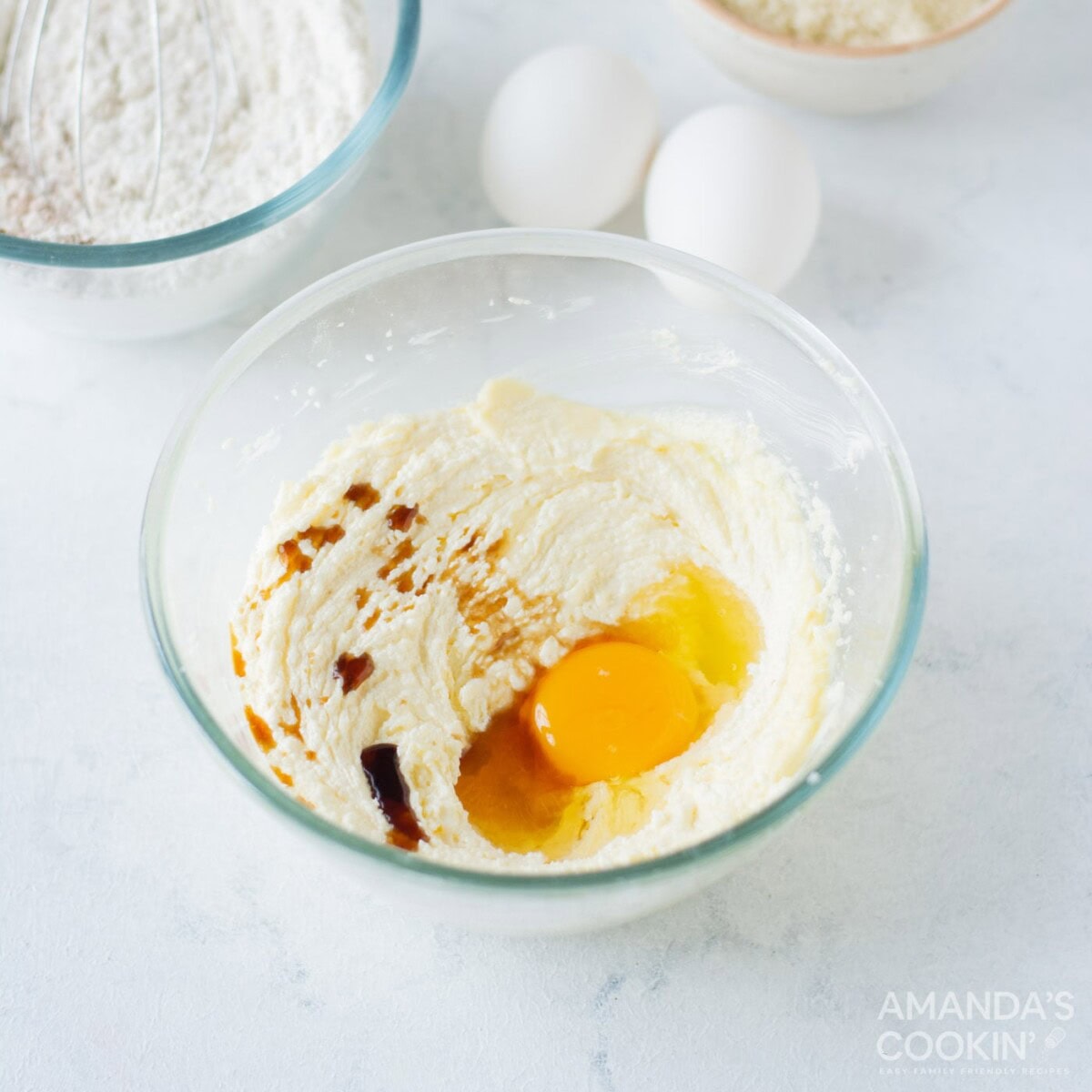 egg and vanilla in butter and sugar mixture