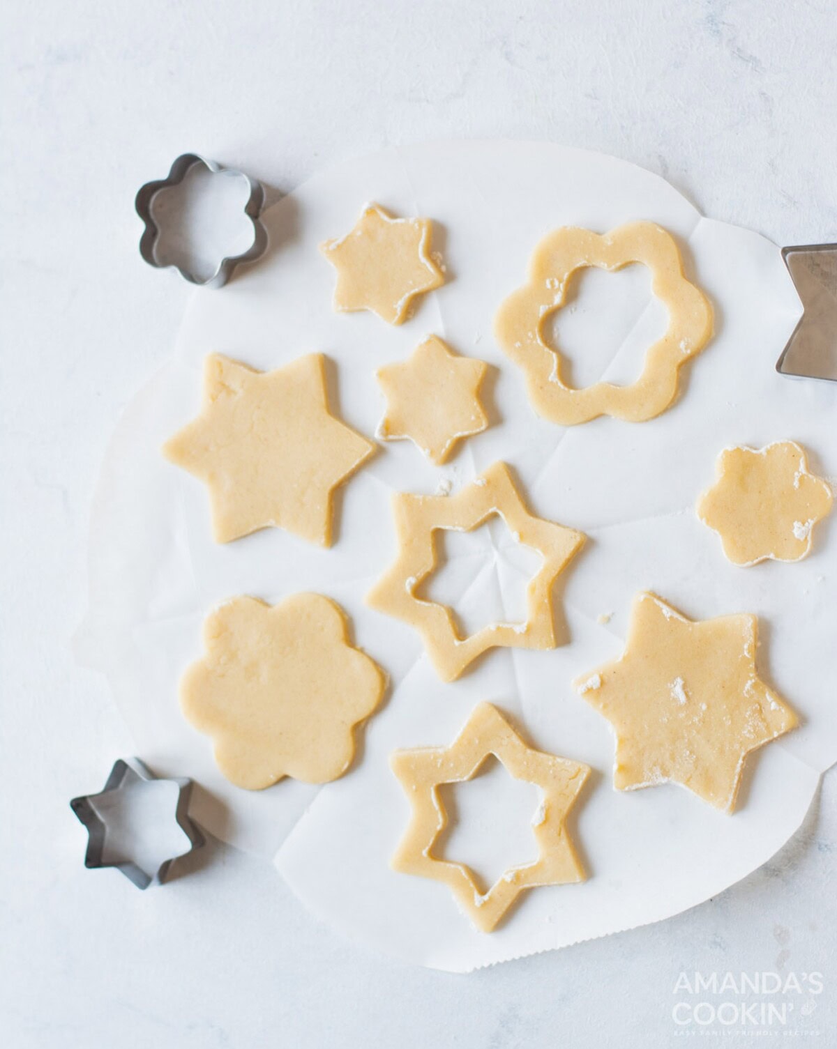 cookie dough cut by cookie cutters into shapes