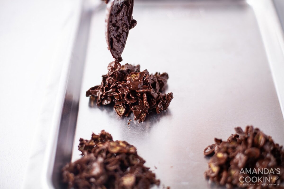 spooning dark chocolate cornflake cookies onto baking sheet