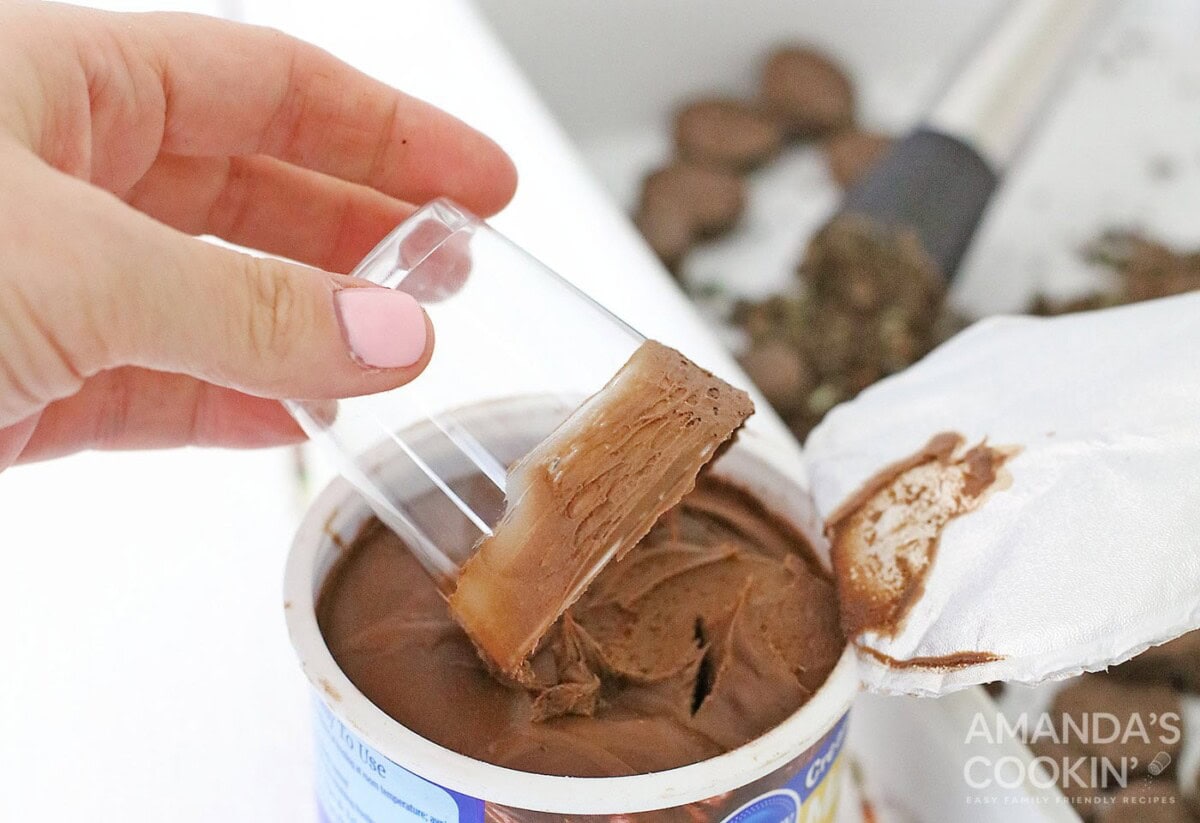 coating top of shot glass with chocolate frosting