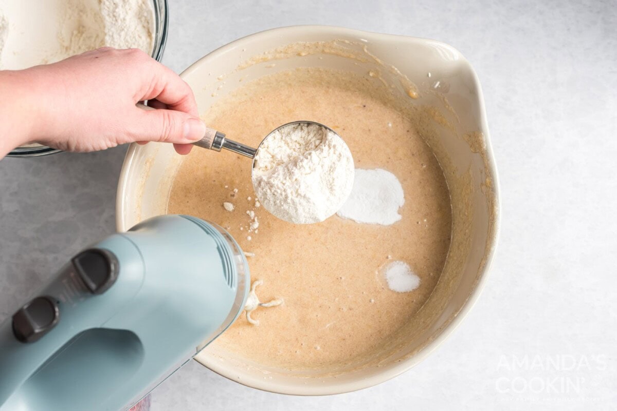 adding flour to bowl