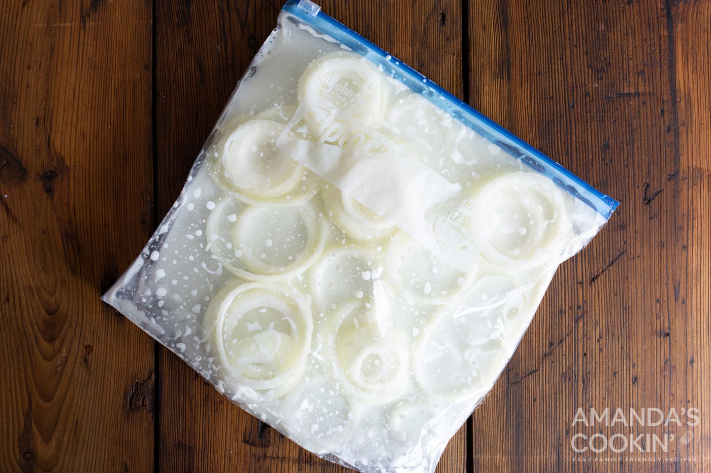 sliced onion in a bag of buttermilk