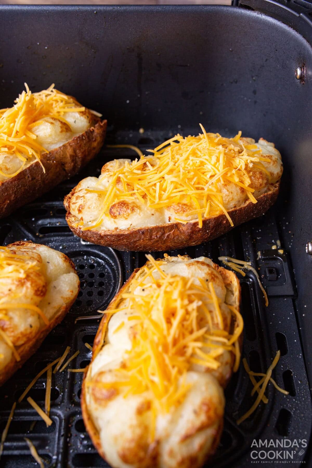 twice baked potatoes with cheese and bacon in air fryer basket