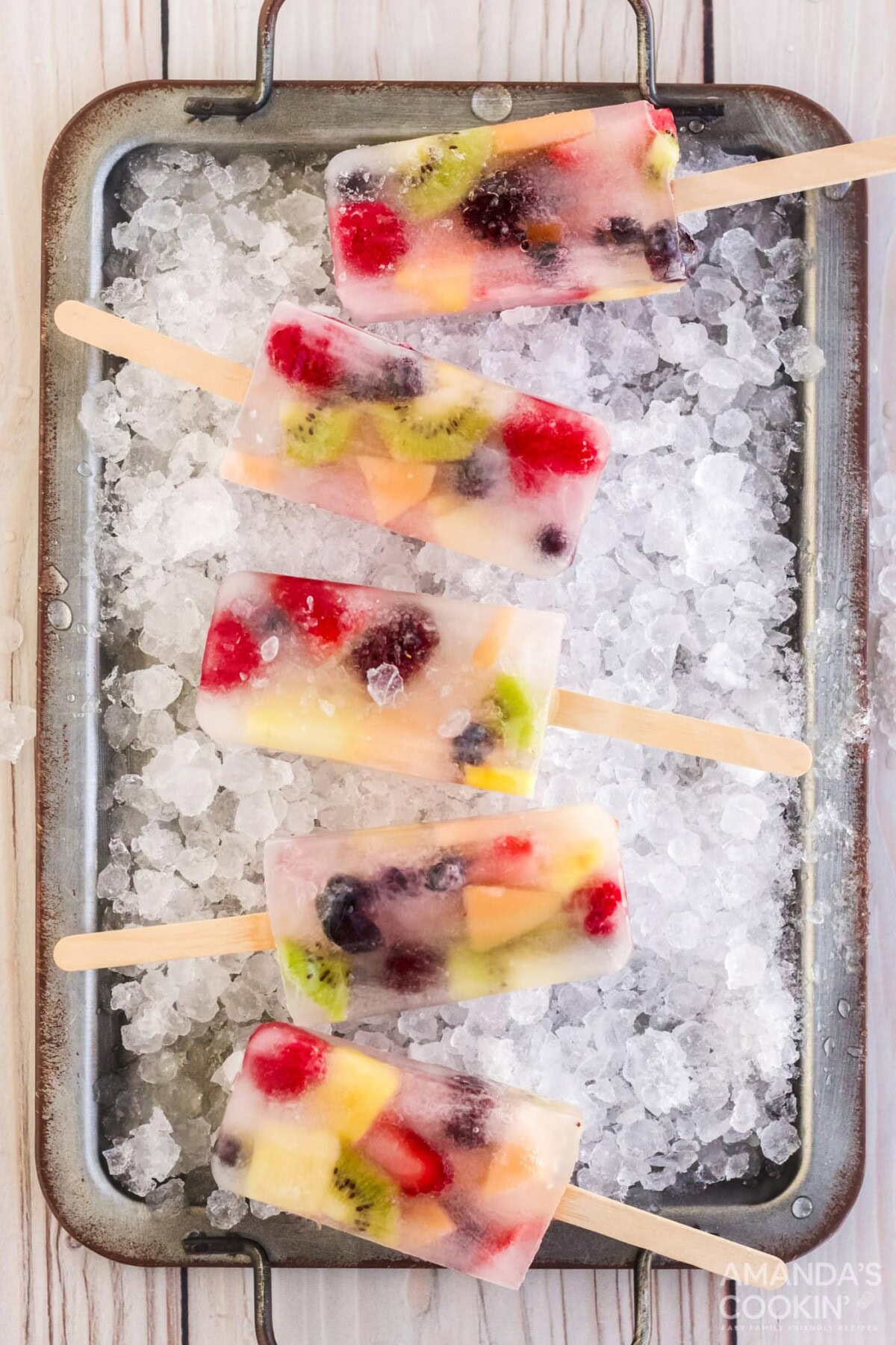 Fruit Popsicles on a tray of ice cubes