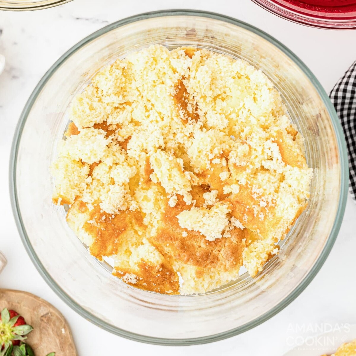 crumbled cake on the bottom of trifle dish