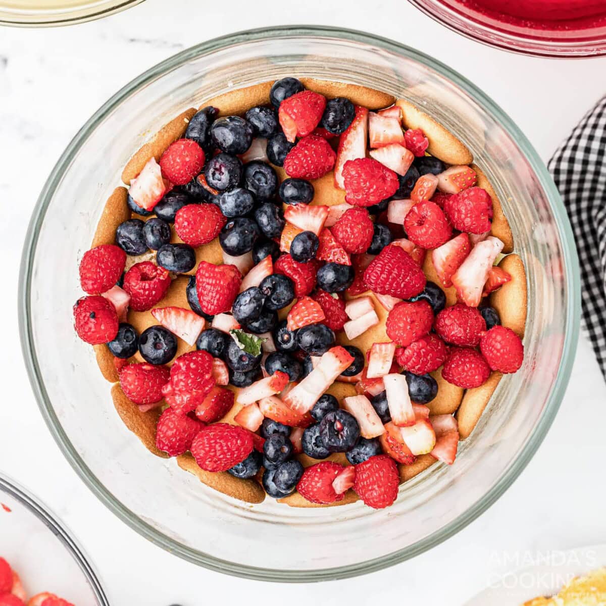 chopped fruit on top of wafers and cake in trifle