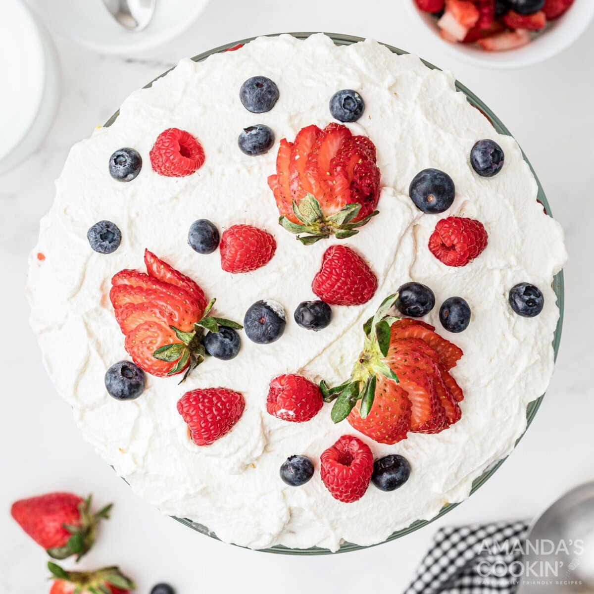 whipped cream and berries on top of trifle