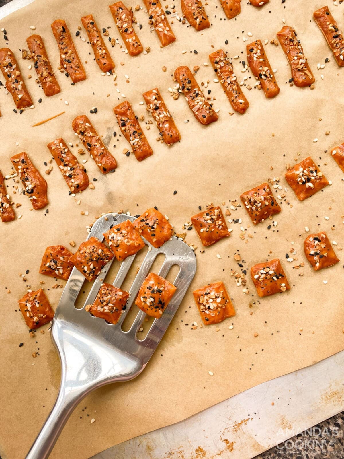 spatula lifting keto cheese crackers from baking sheet