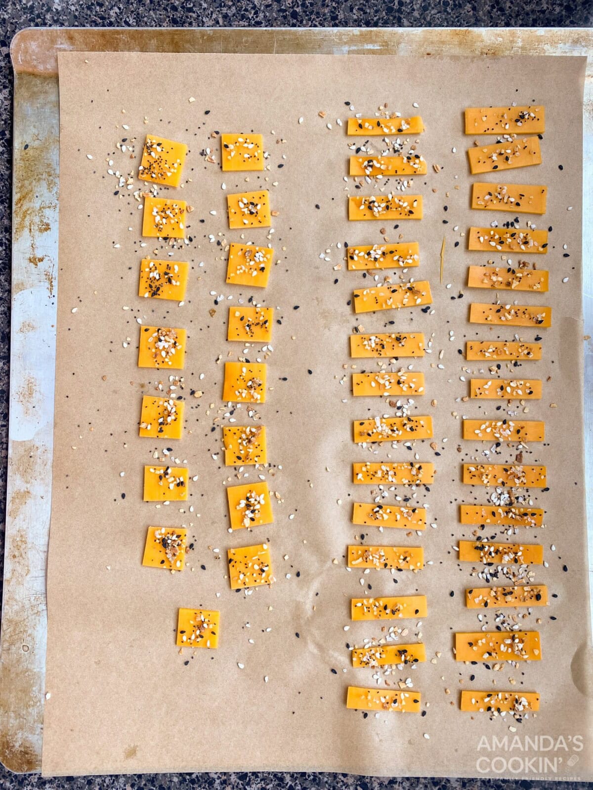 cheese pieces with seasoning on sheet