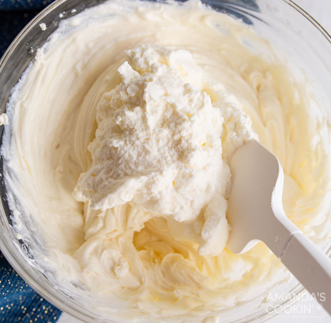 folding together cream cheese mixture into cheesecake mixture