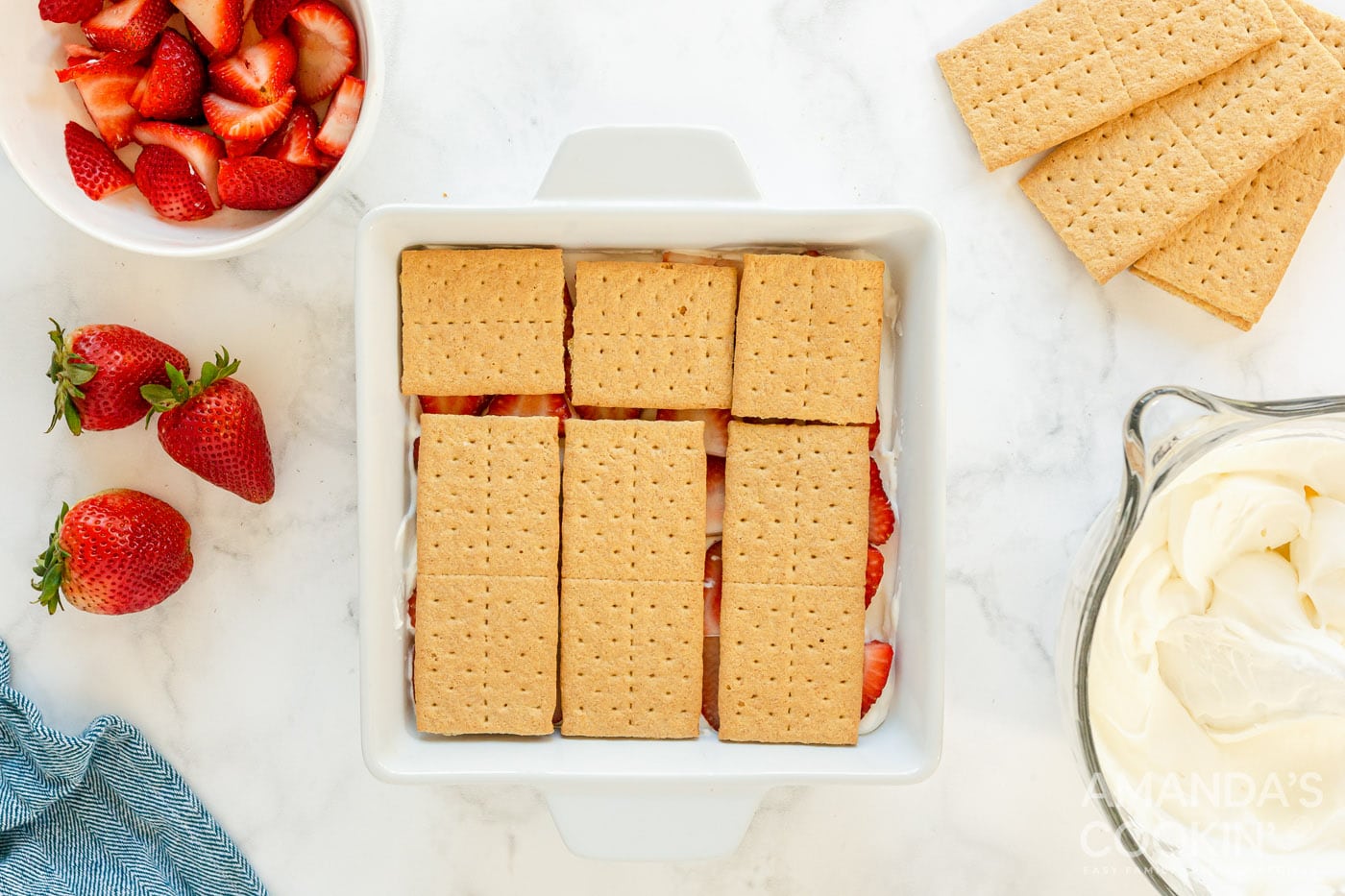 graham cracker layered on top of strawberries overhead shot