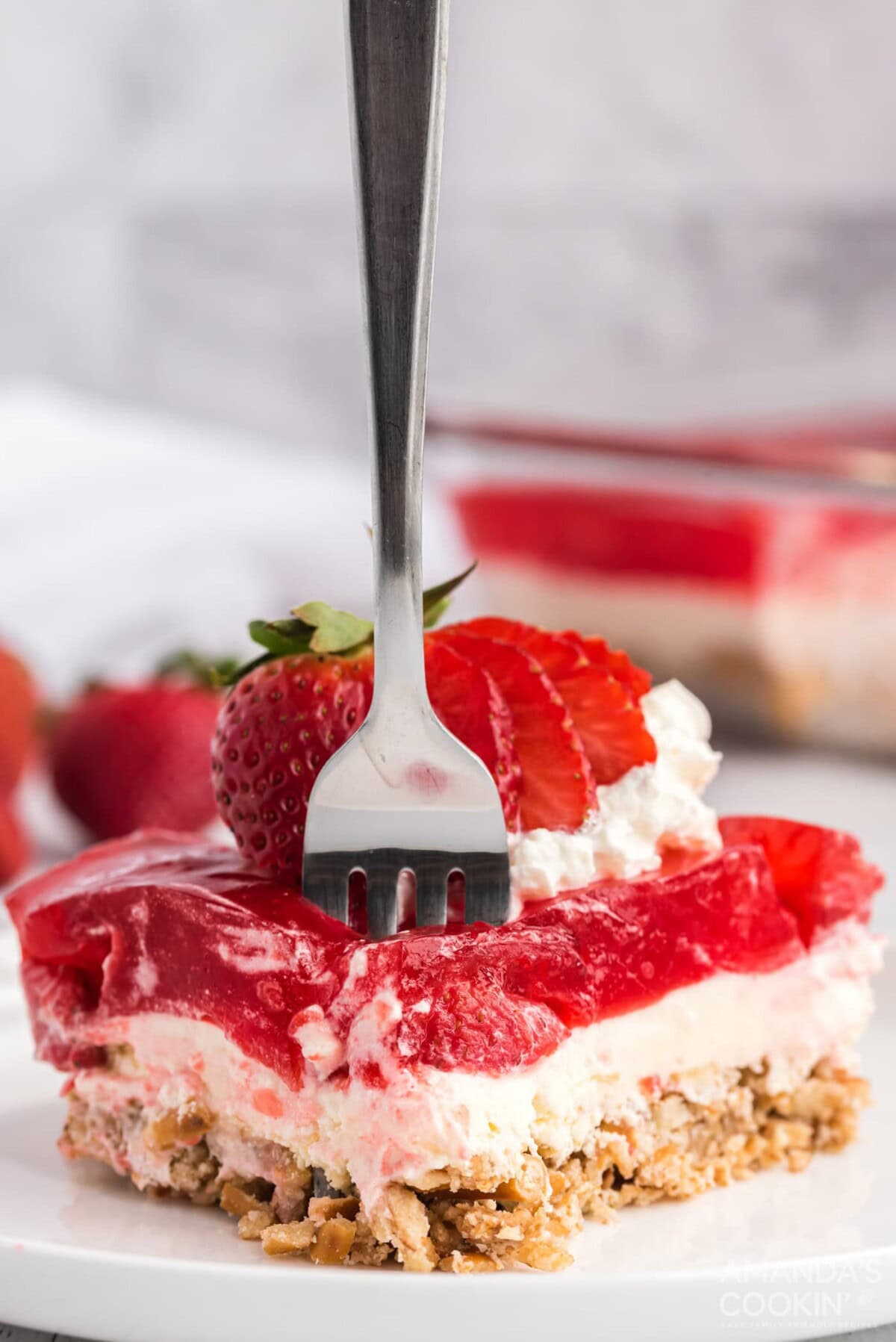 fork in a slice of Strawberry Pretzel Salad