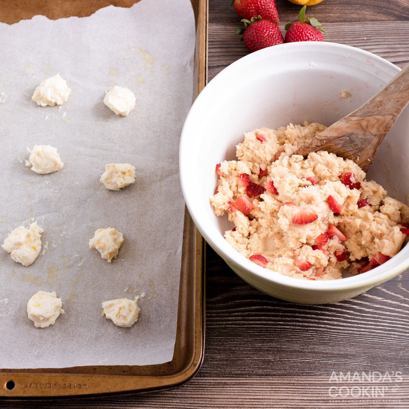 cream cheese balls on baking sheet next to bowl of strawberry cookie dough