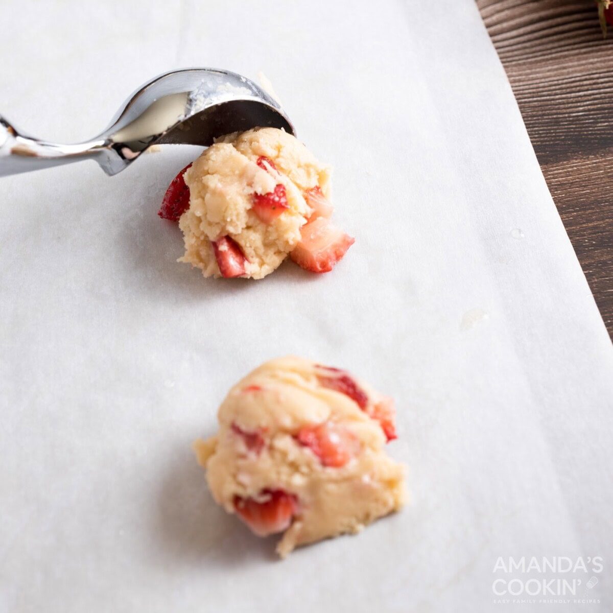 scooping cookie dough onto baking sheet