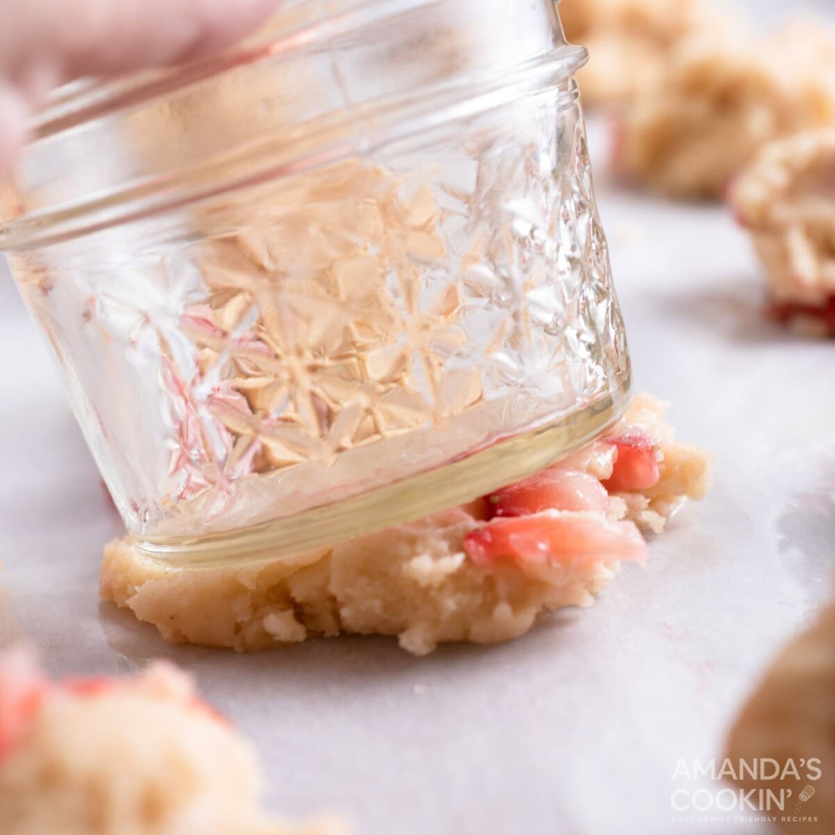 using a mason jar to flatten cookie dough balls