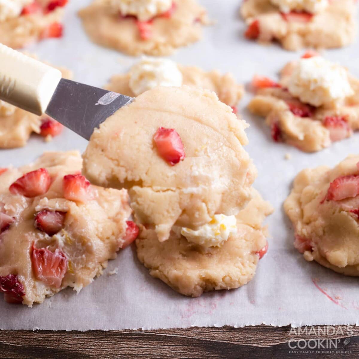 placing cookie dough on top of cream cheese balls