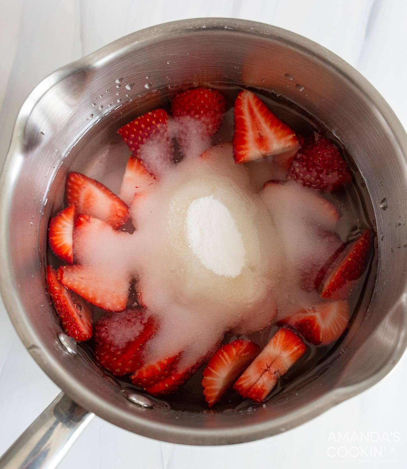 sliced strawberries, sugar, and water in a saucepan