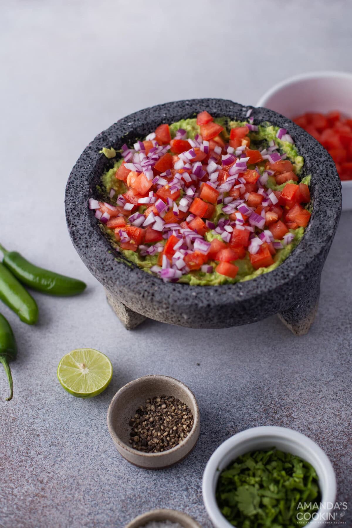onion, tomato, and cilantro in avocado mixture