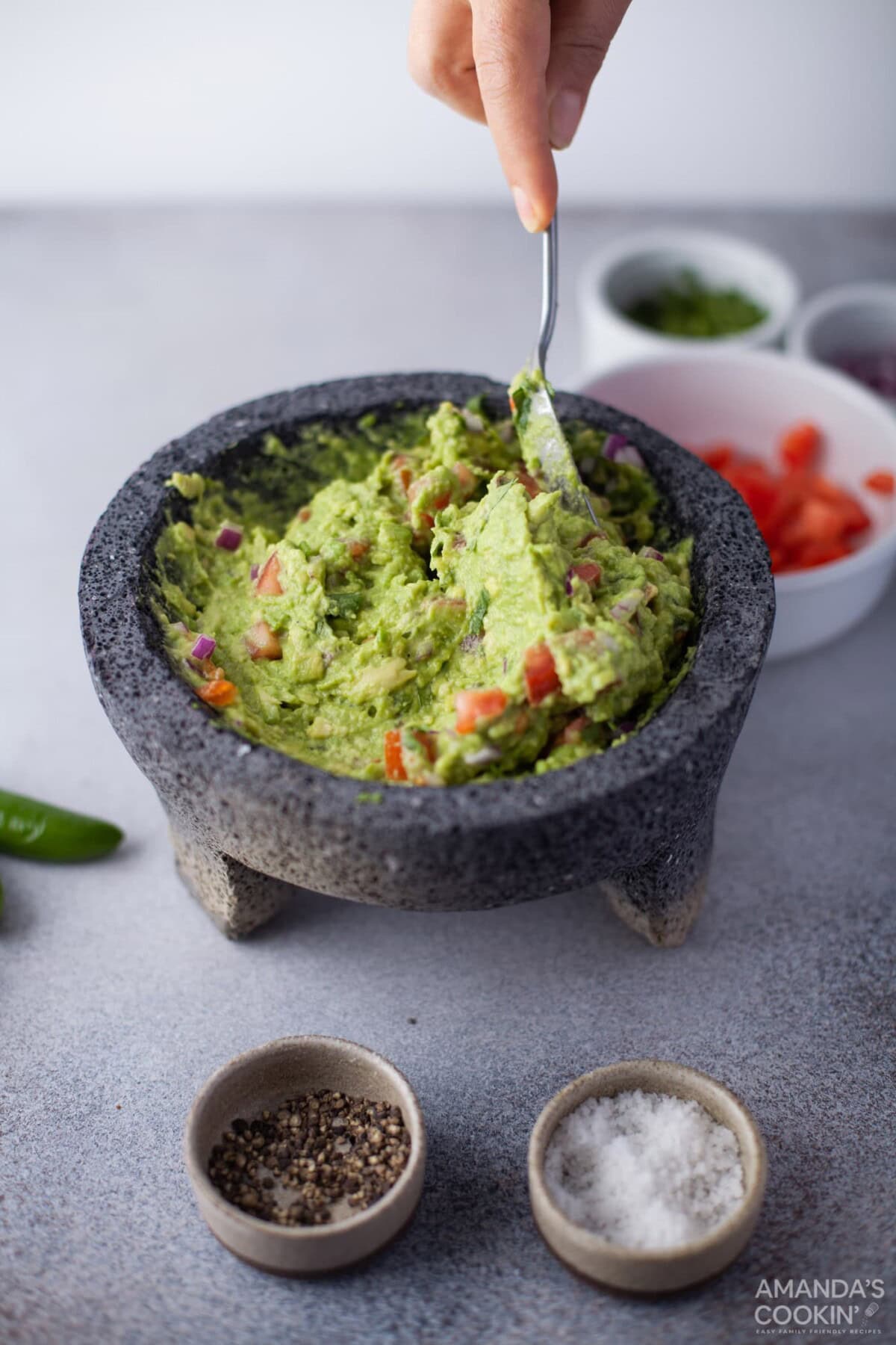 mixing guacamole with a spoon