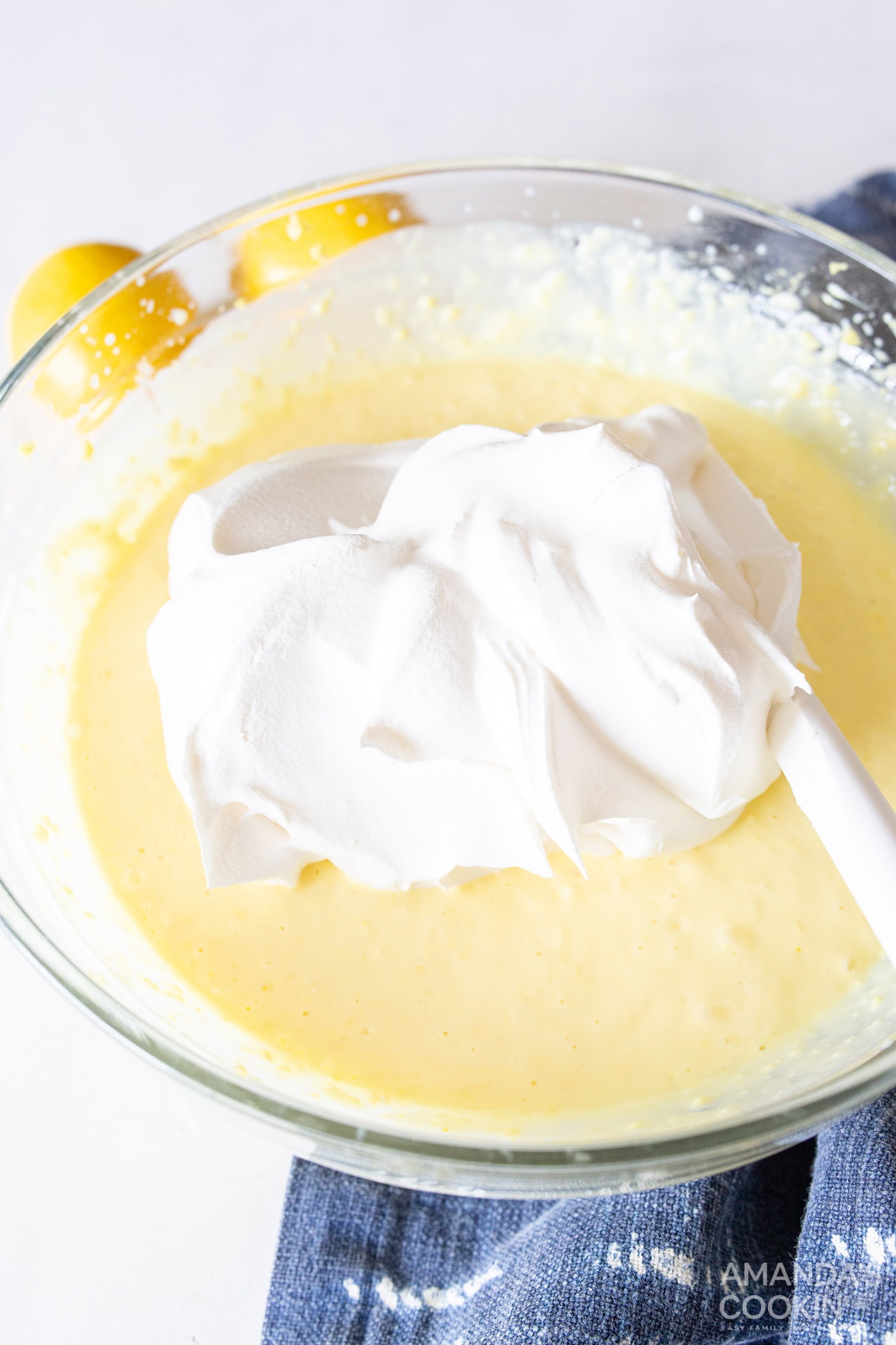 cool whip in bowl of lemon pudding