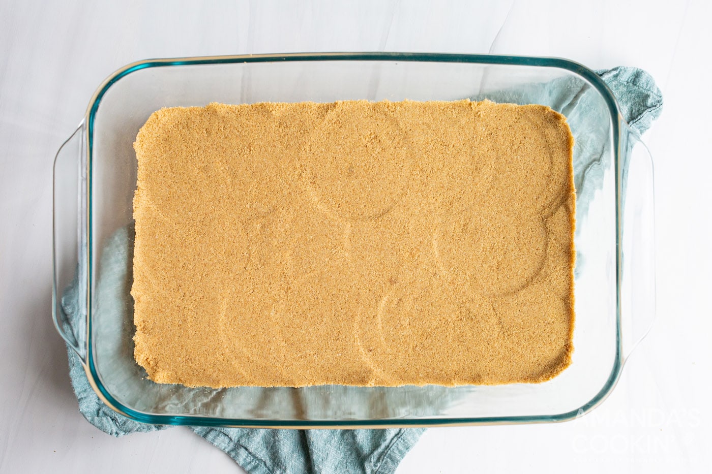 graham cracker forms a crust in a baking dish
