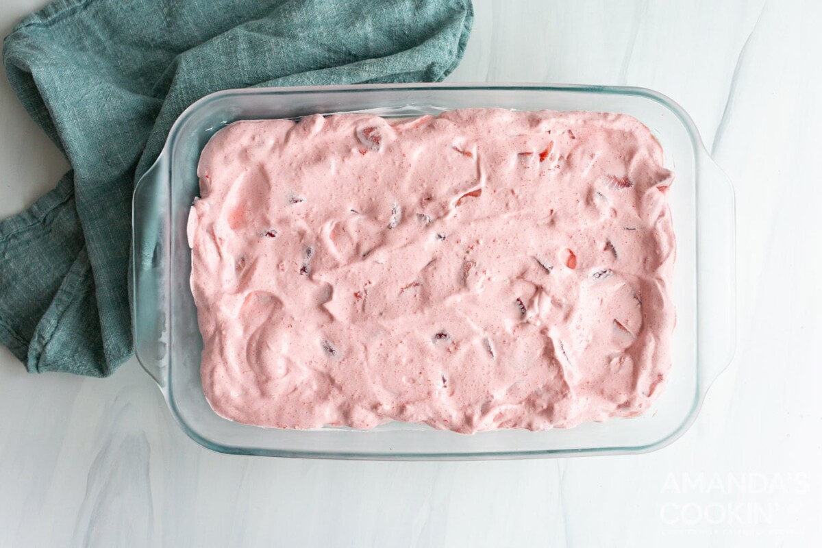 strawberry jello mixture in baking dish