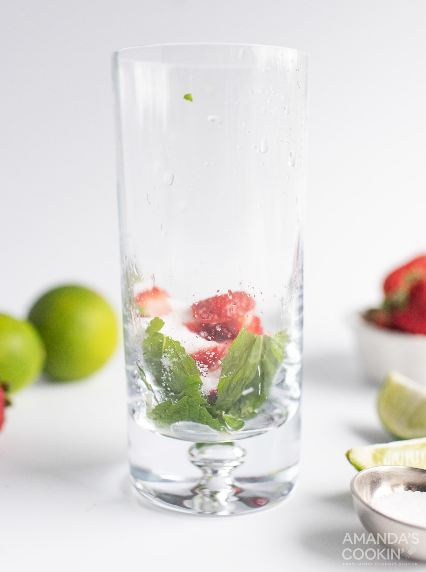mint leaves and strawberries in highball glass