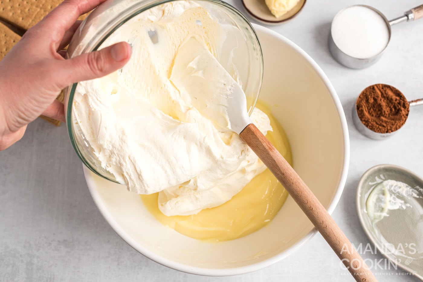 adding whipped topping to pudding mix