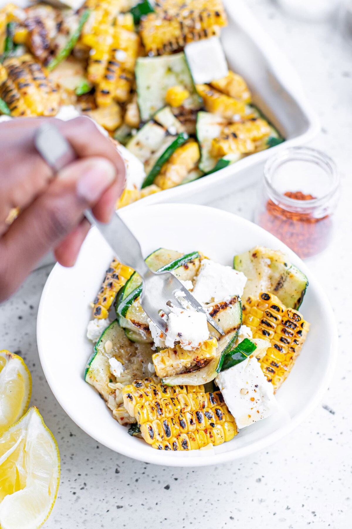 grabbing some Grilled Corn & Zucchini Salad with Feta with a fork