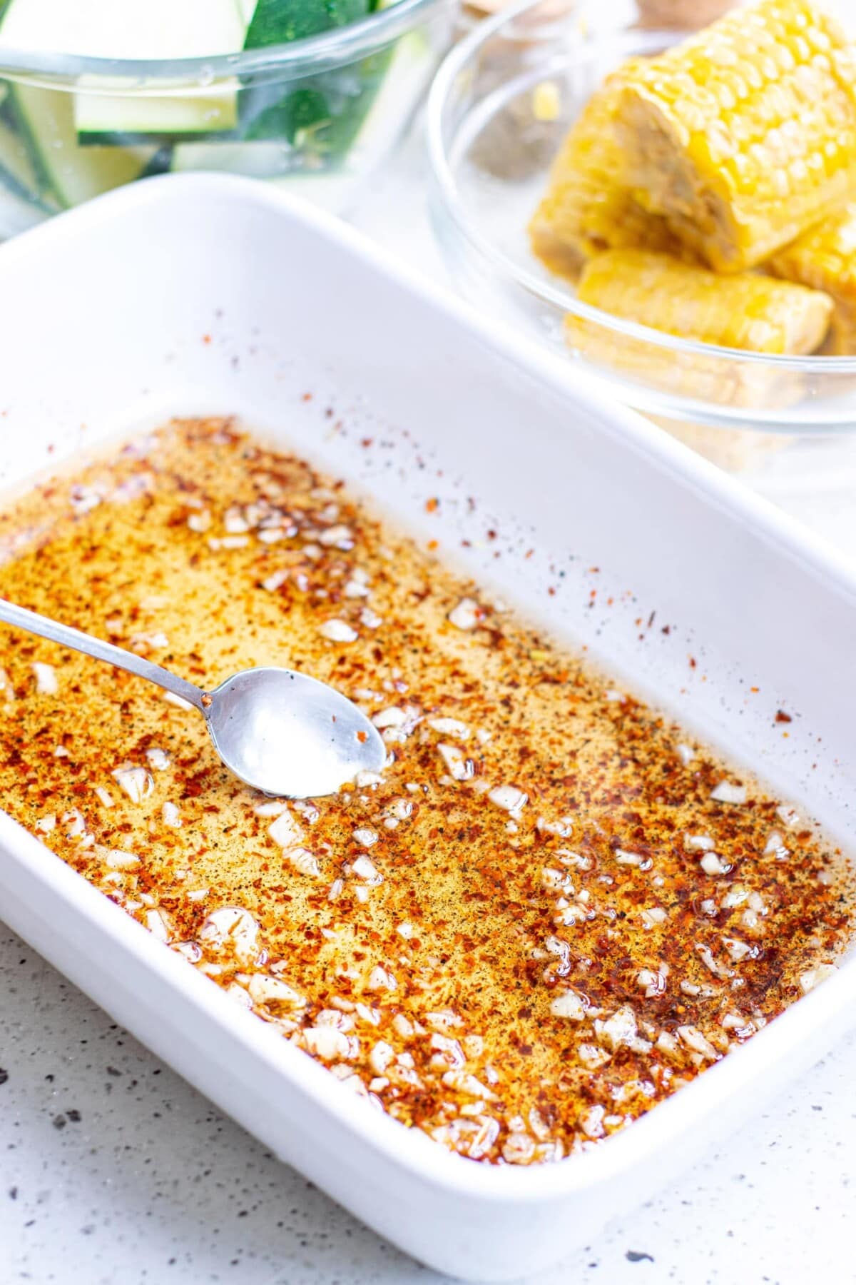 olive oil with salt and pepper and garlic in a baking dish
