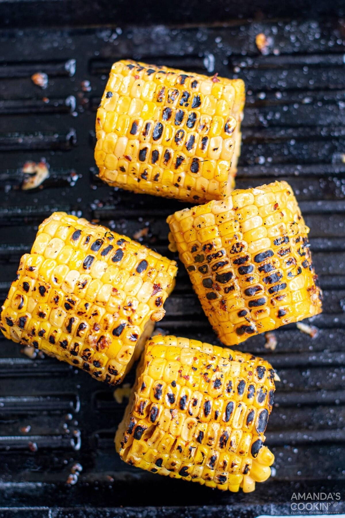 charred corn cobs on grill