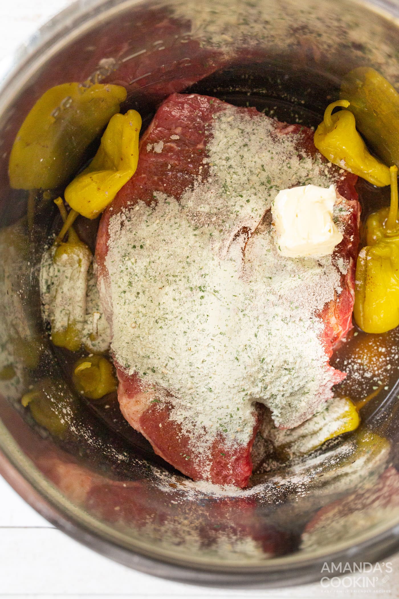 chuck roast with seasonings and pepperoncinis in instant pot