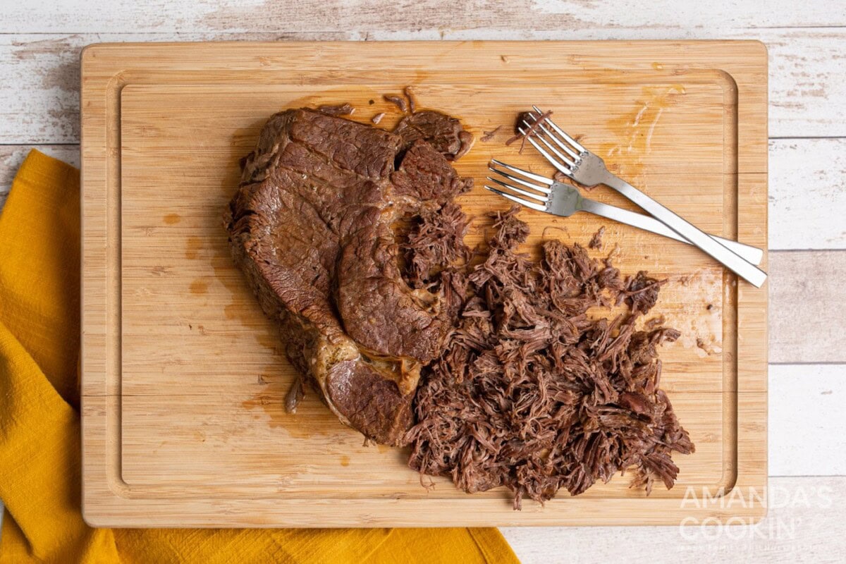 shredded chuck roast on cutting board