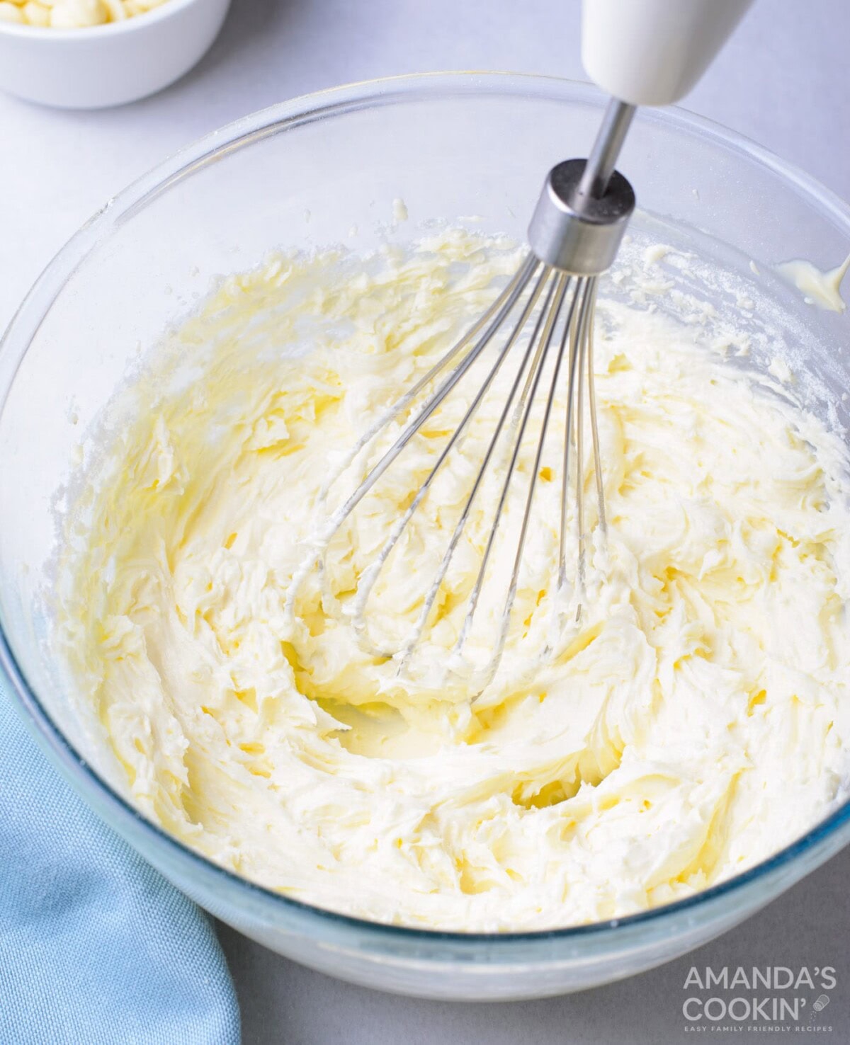 mixing buttercream frosting in a bowl