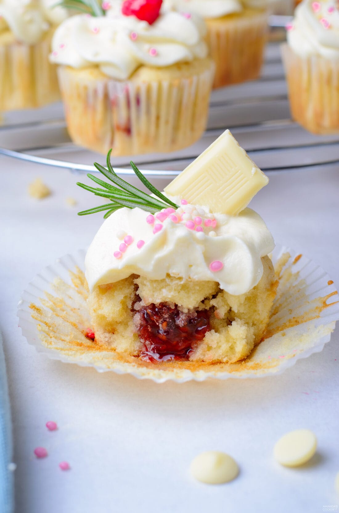 Raspberry White Chocolate Cupcakes cut in half showing filling
