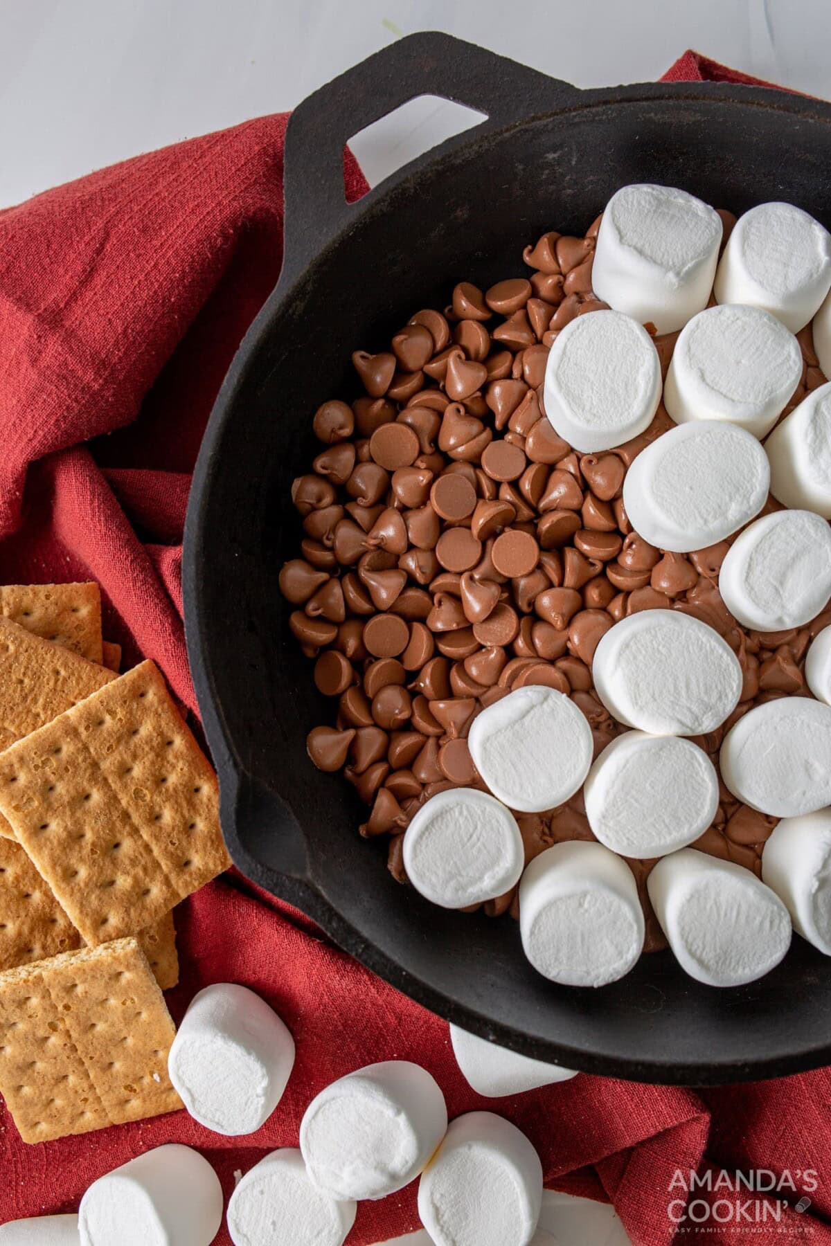 marshmallows on top of chocolate chips in a skillet