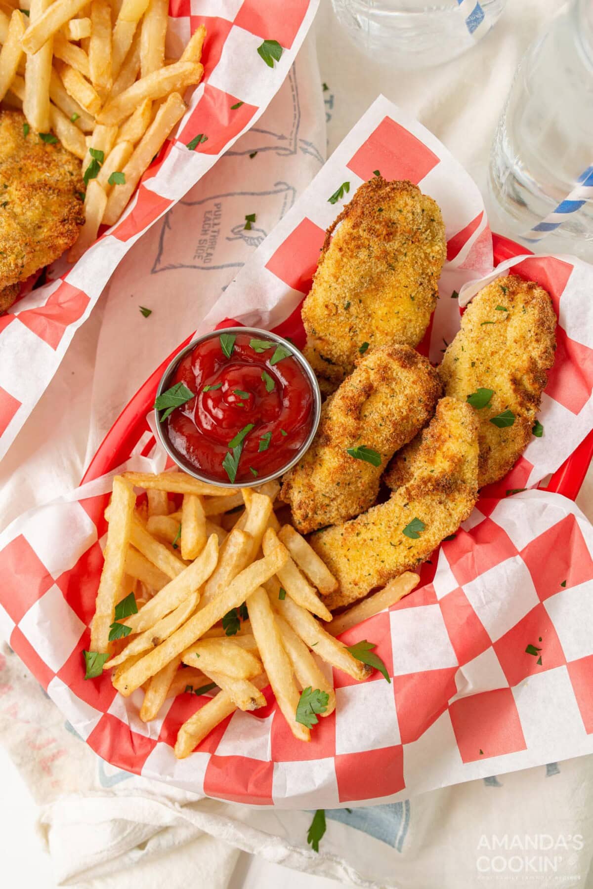 air fryer chicken tenders in baskets with fries