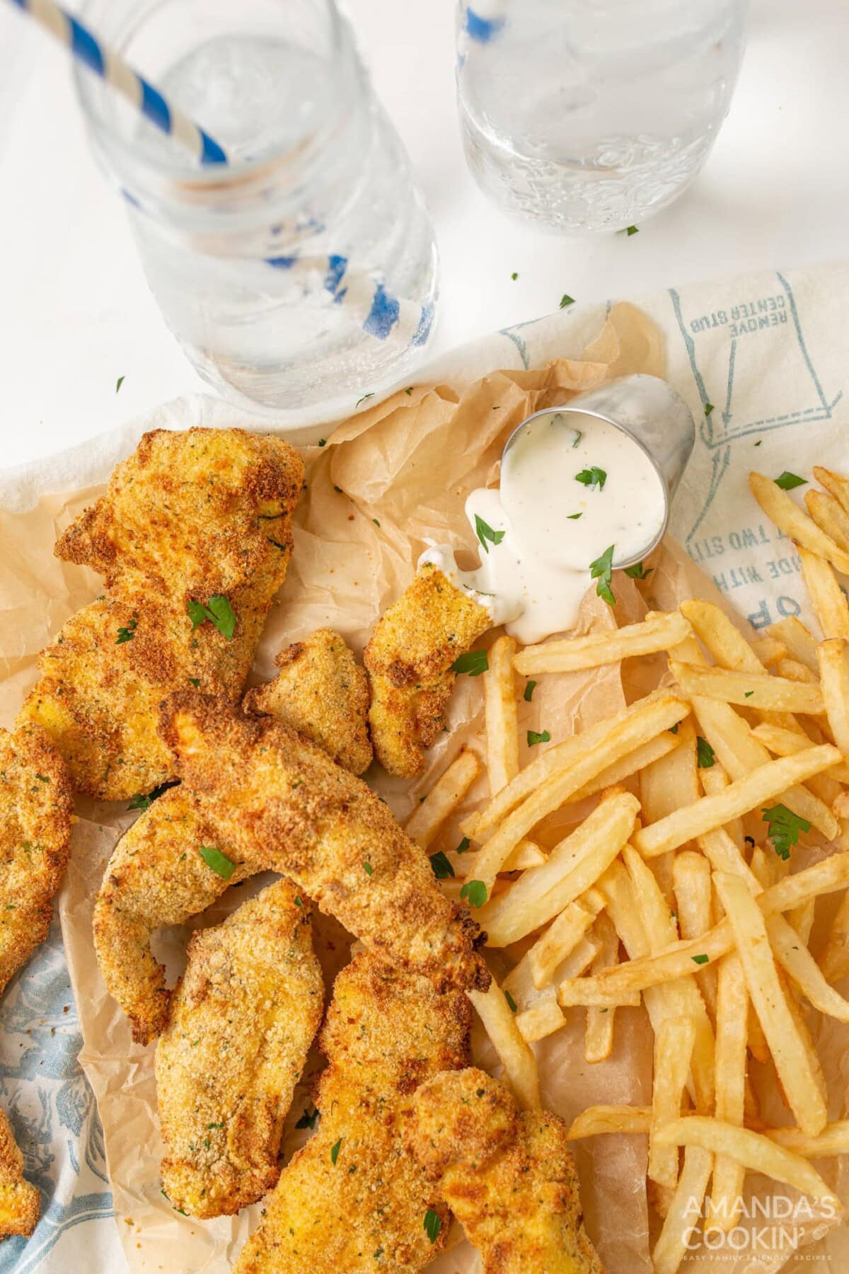 air fryer chicken tenders with fries on parchment