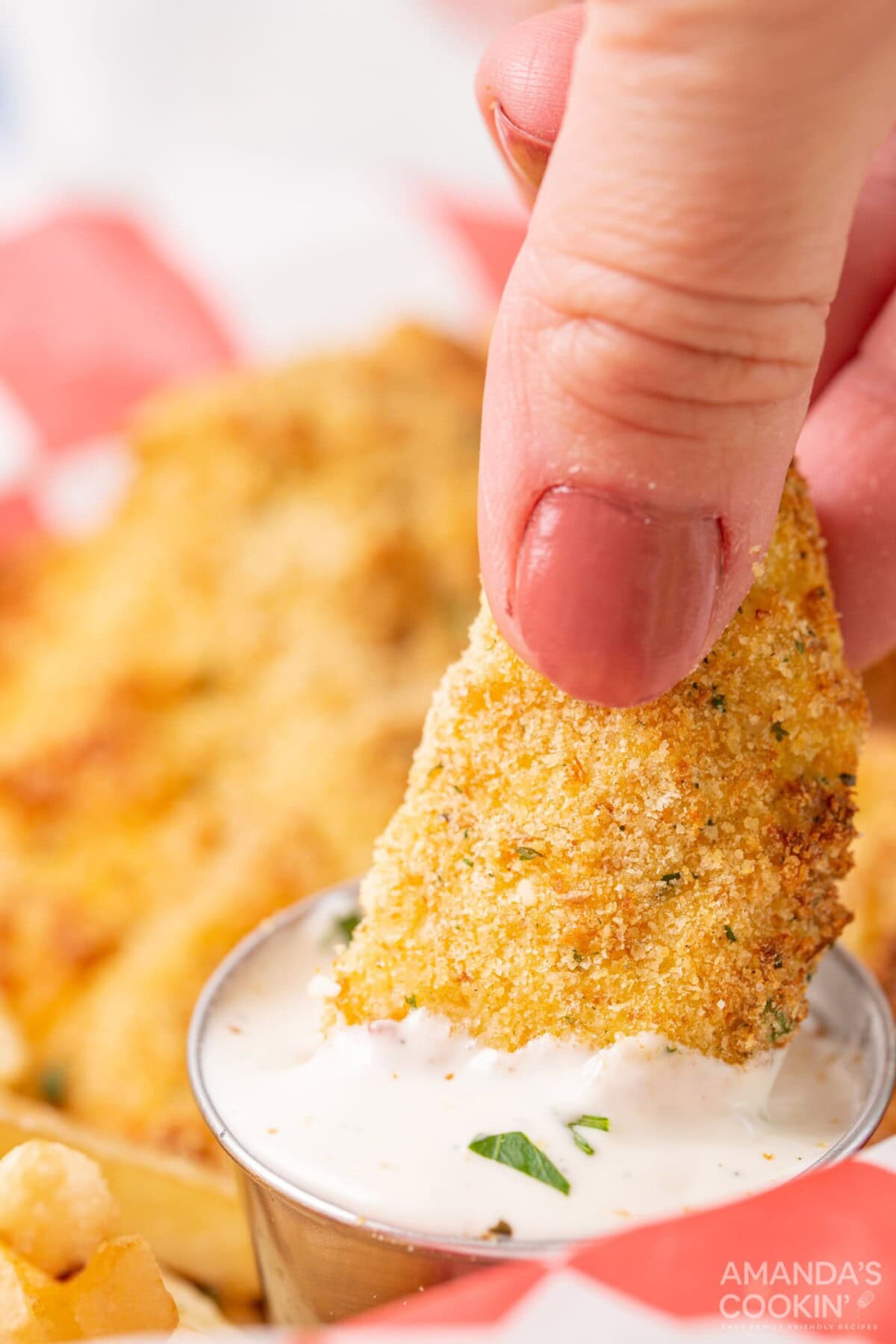 dipping chicken tender in ranch