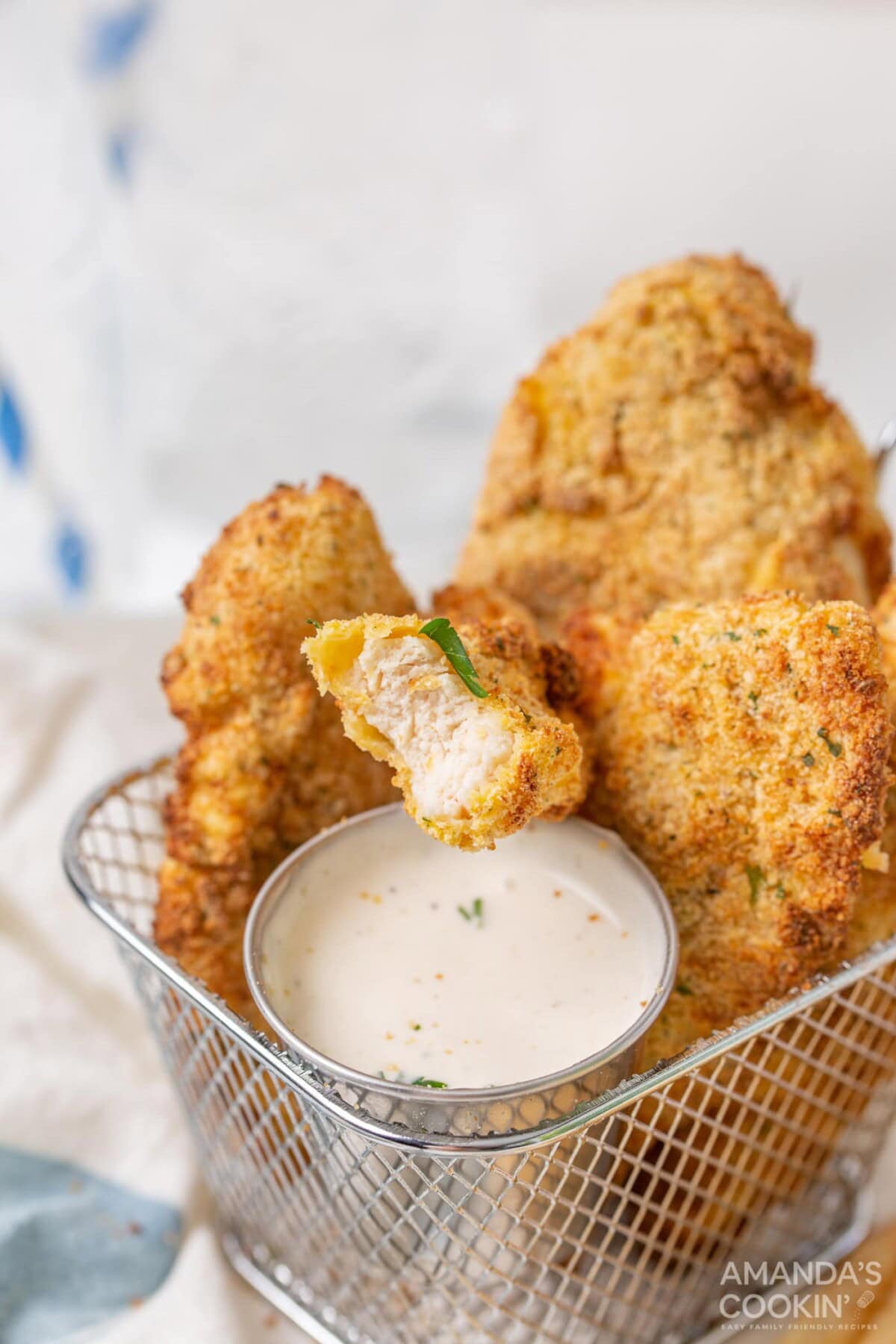 air fryer chicken tenders in basket with ranch