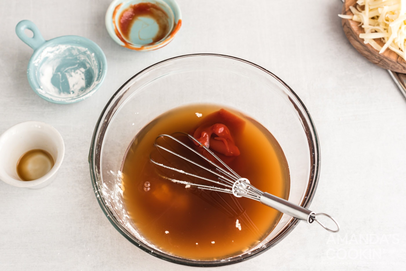 ketchup, Worcestershire sauce and beef broth in a bowl with whisk