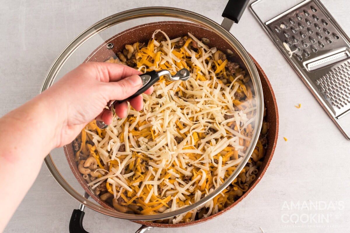 covering skillet with cheese